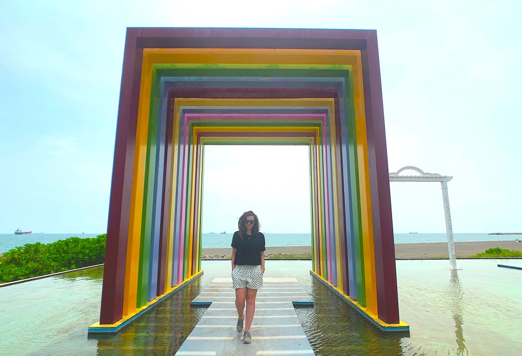 Girl walks through rainbow sculpture on Cijin Island, Kaohsiung, Taiwan. 