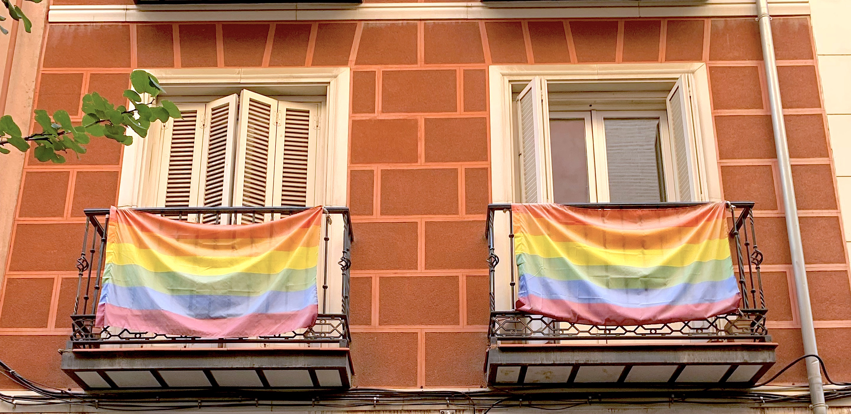 Rainbow flags hang on balconies in Chueca, Madrid
